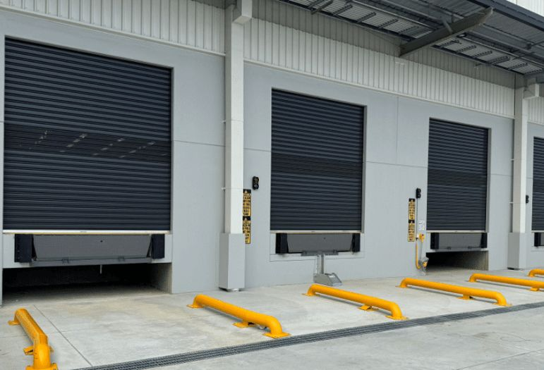 commercial Rolling steel door barrel and spring service at a dock bay